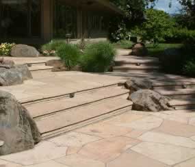The wide, flag stone steps and patio convey a sense of welcome, permit side-by-side strolling, and safety.